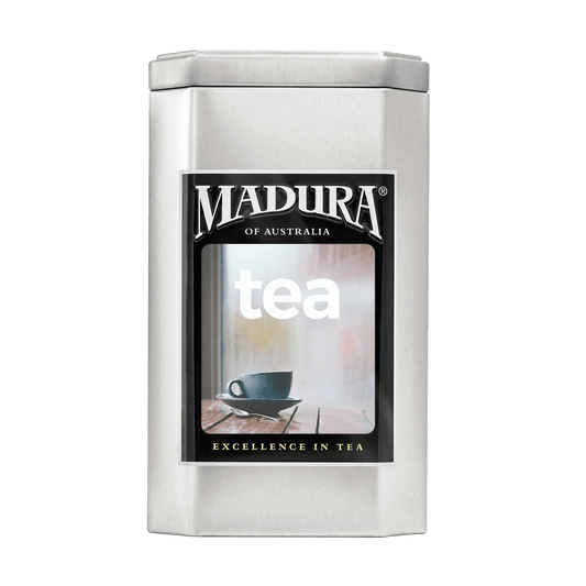 Empty Caddy with Blue Cup and Spoon on Table Label - Madura Tea